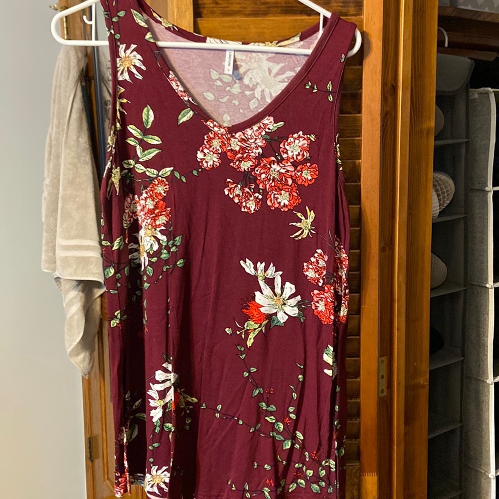 Maroon sleeveless top with floral design.